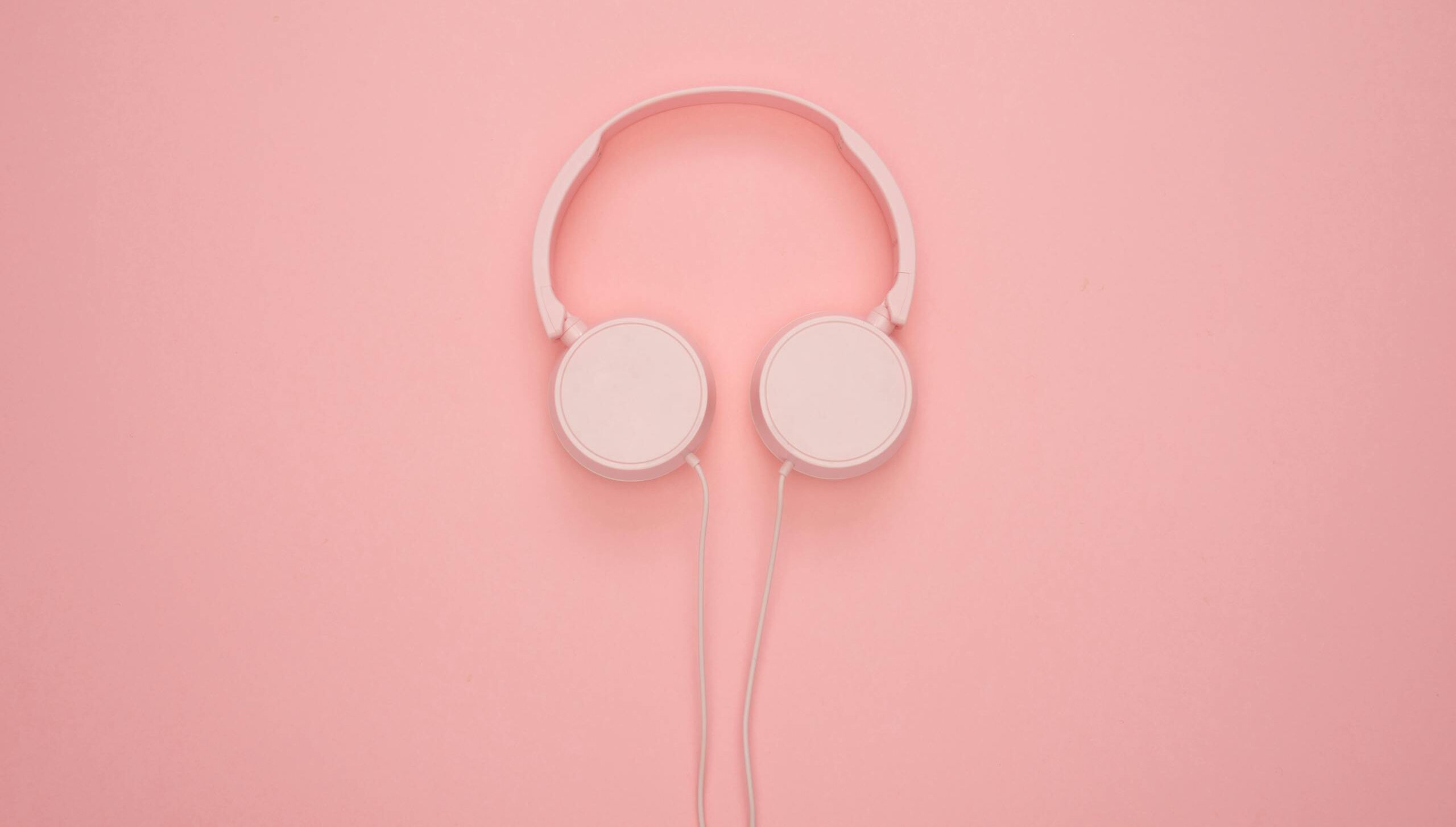Aesthetic pink headphones on a pastel background, perfect for a modern and stylish look.